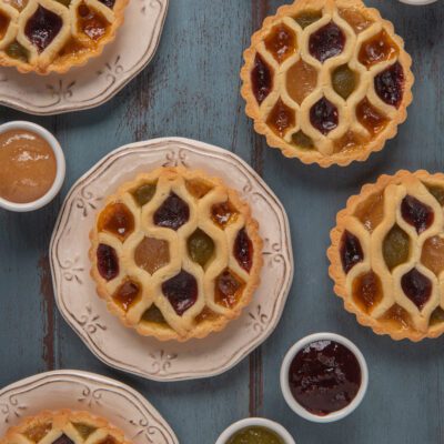 Crostatine arcobaleno con reticolo a nido d'ape e marmellate di tre colori diverse