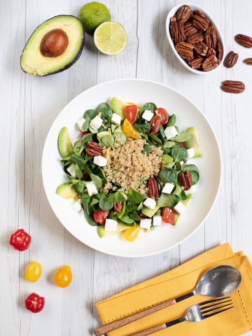 Insalata di songino con quinoa, avocado a fette, primosale a cubetti, pomodorini e noci pecan