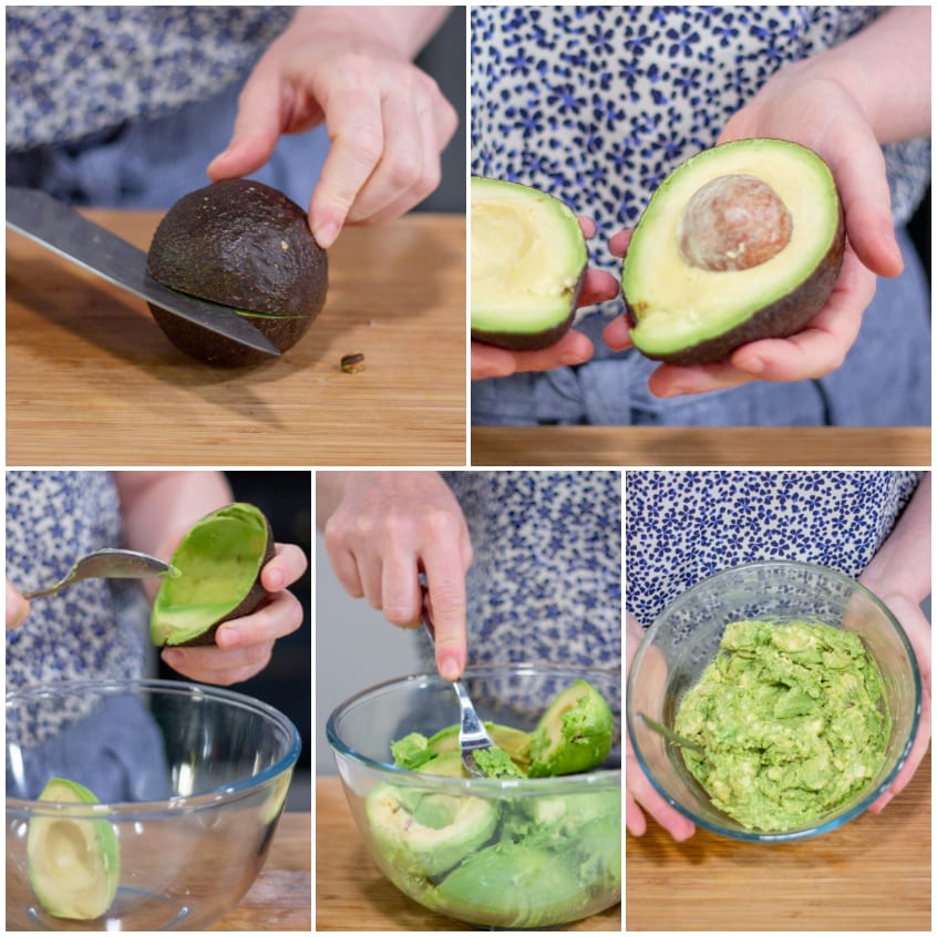 Avocado tagliato a metà, svuotato con un cucchiaio e schiacciato con una forchetta in una ciotola