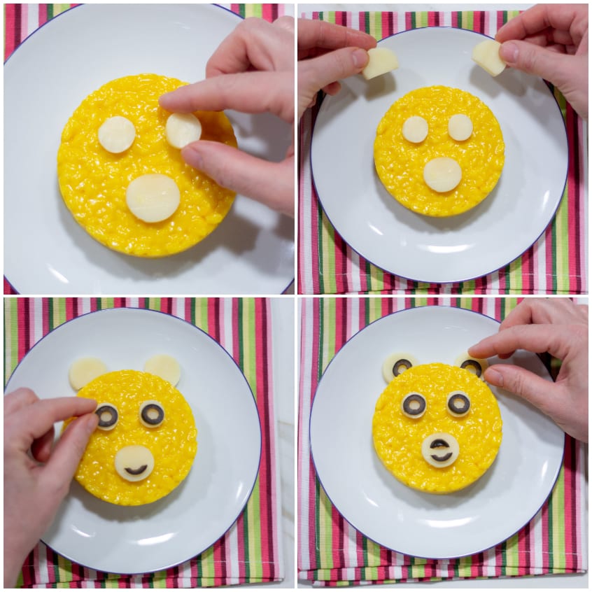 Mani che posizionano rondelle di oliva e dischetti di formaggio sul risotto a forma di orsetto