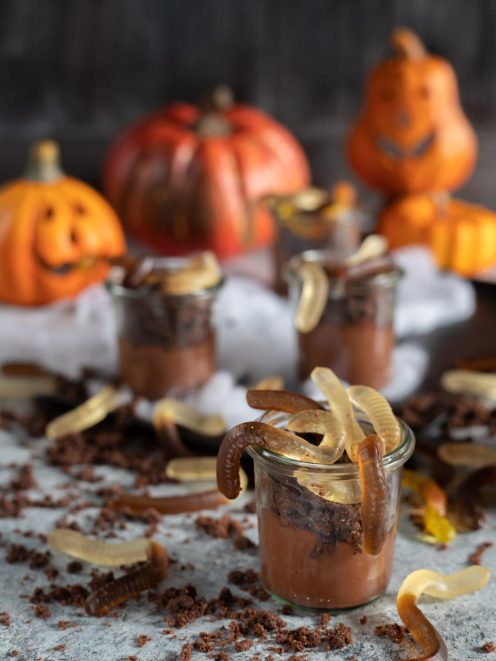 Lombrichi di Halloween nel vasetto con mousse al cioccolato, briciole di biscotto e caramelle gommose a forma di verme