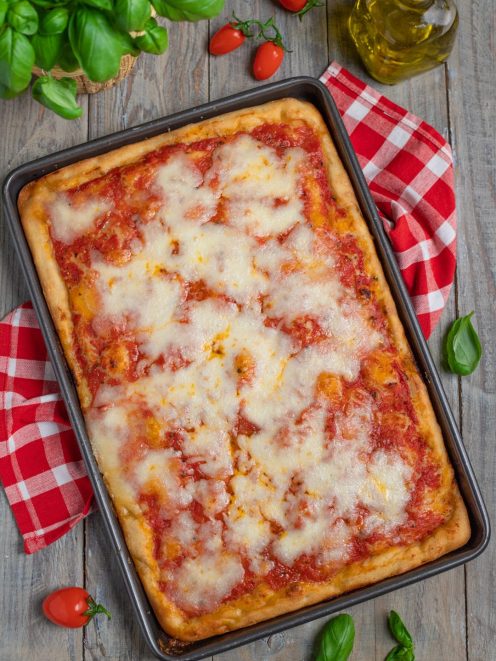 Pizza in teglia con pomodoro e mozzarella filante appena sfornata