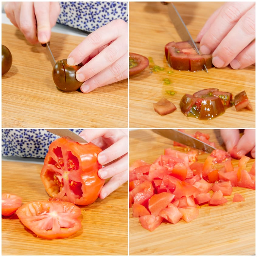 Pomodori camone e cuore di bue tagliati a cubetti su un tagliere di legno