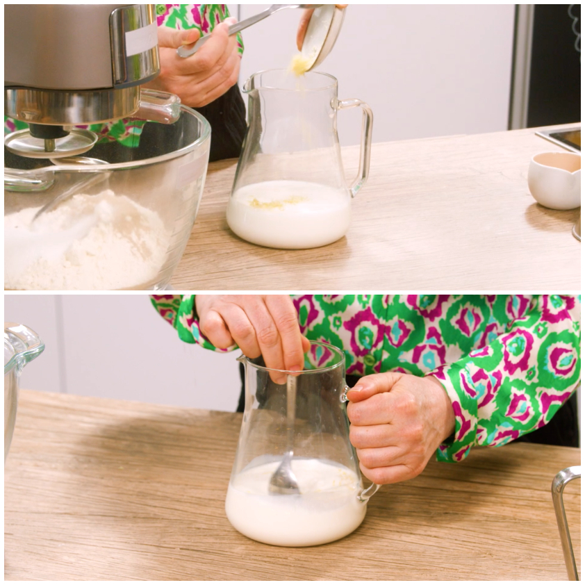 Latte intiepidito in una brocca di vetro con scorza di limone grattugiata, mescolato con un cucchiaio