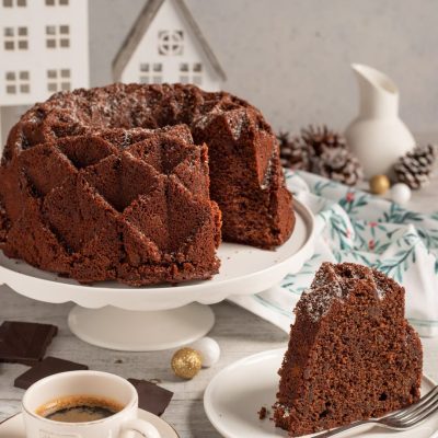 Ciambella cacao e caffè con una fetta tagliata che mostra l'interno soffice al cioccolato