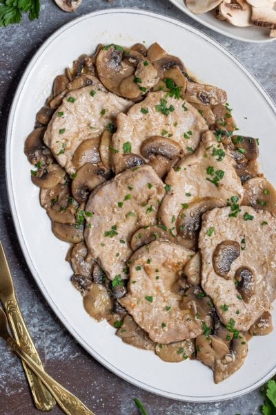 Scaloppine ai funghi con salsa cremosa, funghi champignon e prezzemolo tritato