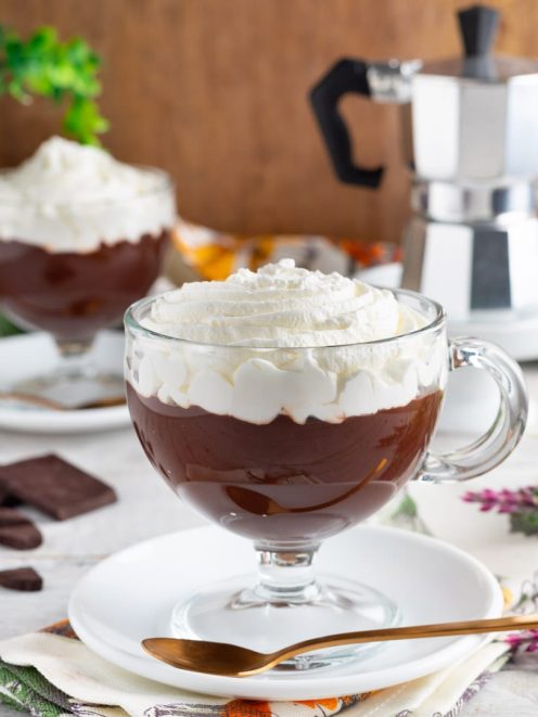 Barbajada servita in tazza trasparente con abbondante panna montata sopra la crema al cioccolato