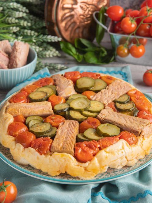 Torta rovesciata al tonno con pomodorini, zucchine a rondelle e strisce di tonno su pasta dorata