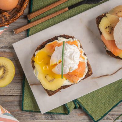 Crostone con kiwi, salmone affumicato e uovo pochè su pane integrale con crema al formaggio