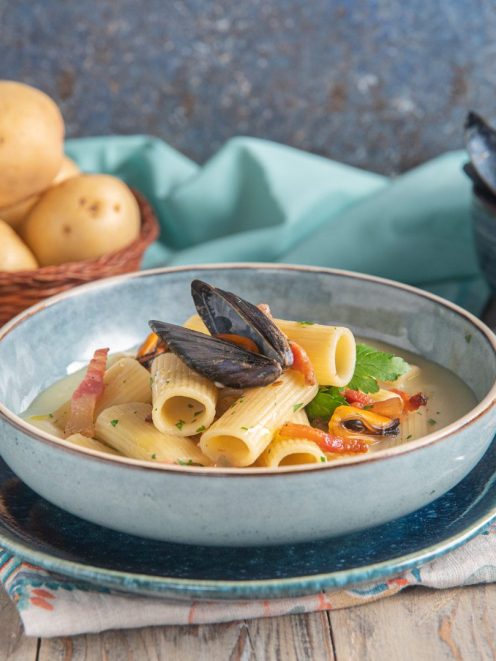 Rigatoni con crema di patate, cozze e guanciale croccante in una fondina fumante