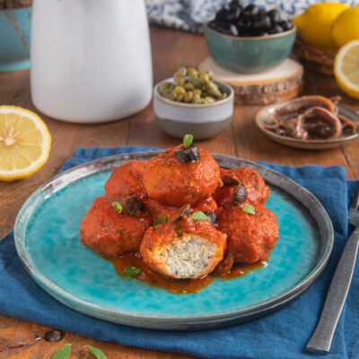Polpette di branzino alla mediterranea in sugo di pomodoro con olive nere e origano fresco