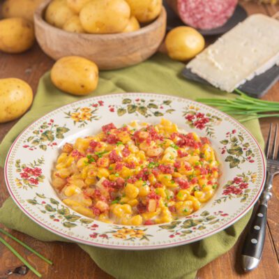 Spatzle alla zucca con gorgonzola, patate e briciole di salsiccia guarnite con erba cipollina