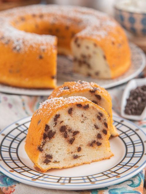 Ciambella di albumi, yogurt e gocce di cioccolato affettata e cosparsa di zucchero a velo