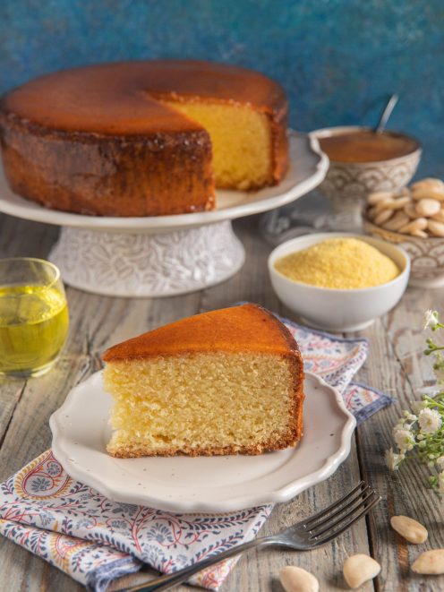 Torta Arluno con crosta caramellata, servita a fette accanto a farina di mais e mandorle