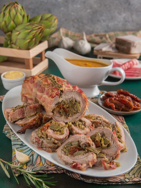 Arrotolato di vitello con carciofi e pomodori secchi affettato e avvolto in pancetta croccante