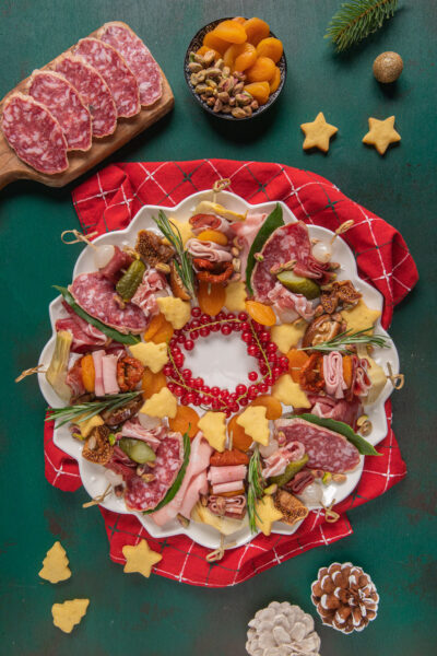 Charcuterie di Natale con salame, prosciutto, formaggi a stella, albicocche secche e pistacchi