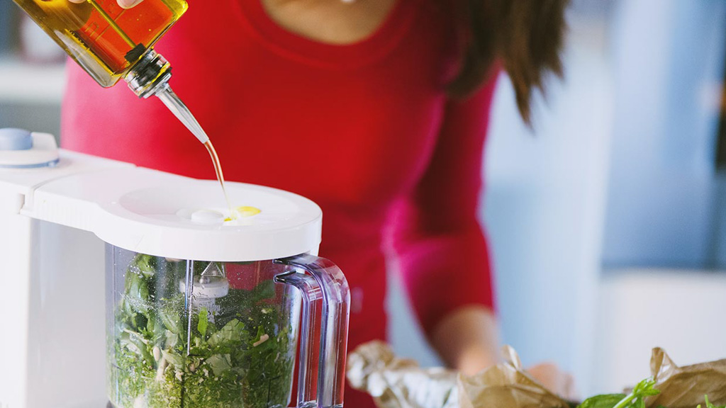 Pesto alla genovese in lavorazione: olio versato a filo nel mixer a impulsi