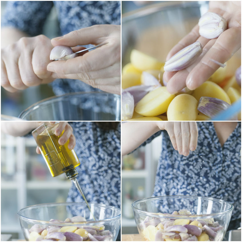 Mani che pelano aglio e condiscono patate e scalogni con olio e sale