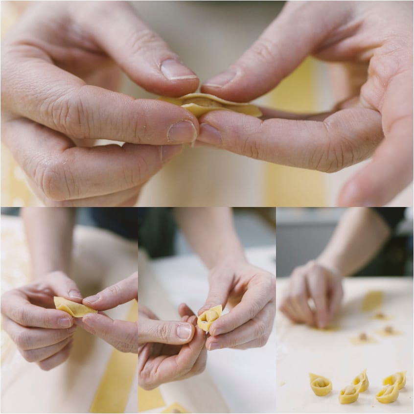 Mani che chiudono e formano i tortellini unendo le punte della pasta all'uovo