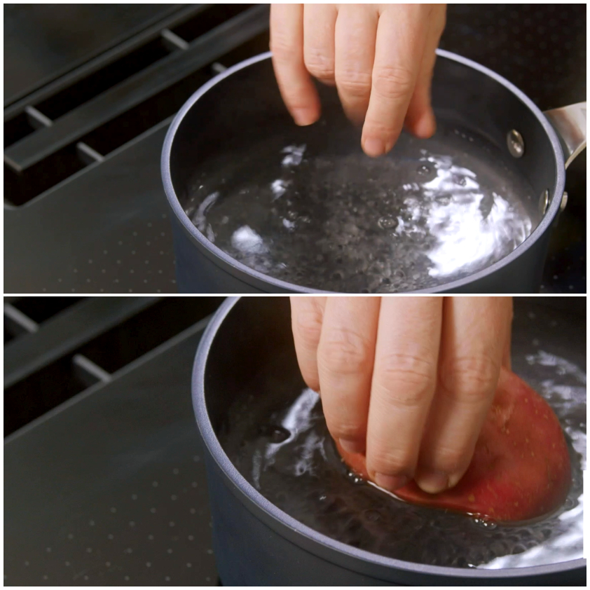 Una patata rossa immersa a mano in acqua bollente in casseruola