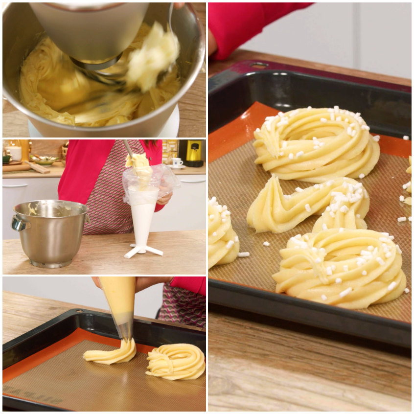 Ciambelline e forme a v di pasta choux decorate con codette bianche su teglia foderata