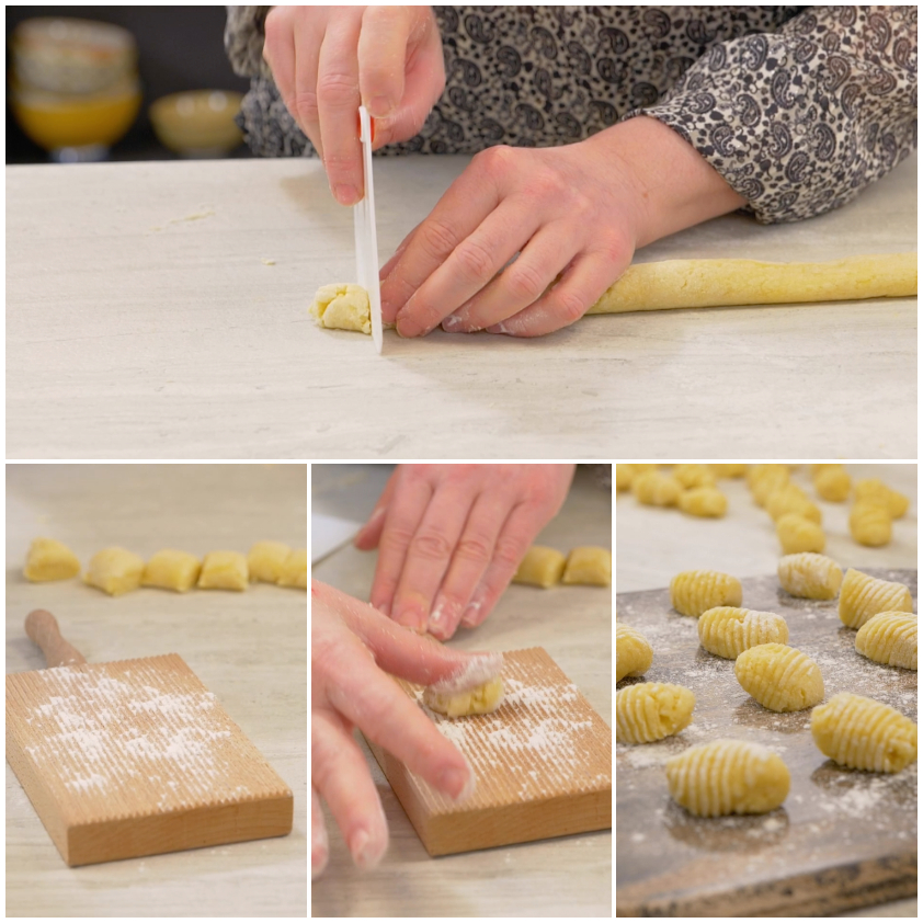 Porzioni di impasto per gnocchi arrotolate a formare filoncini sul piano di lavoro