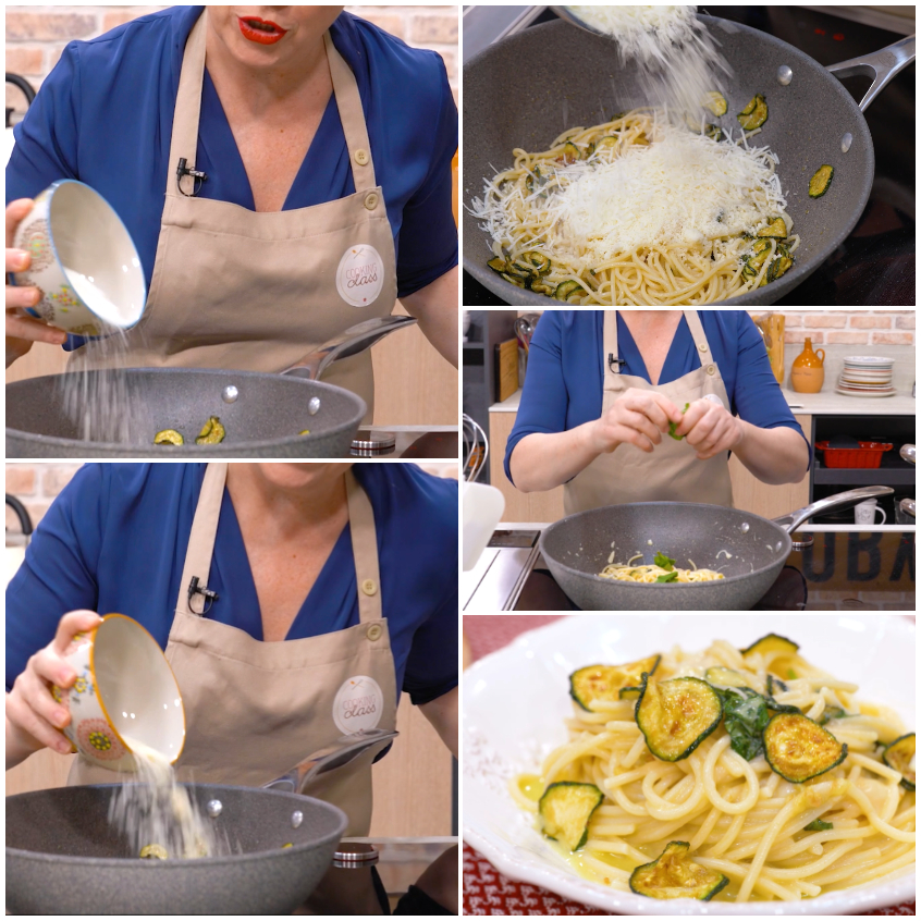 Formaggio grattugiato versato sulla pasta con zucchine in padella durante la mantecatura
