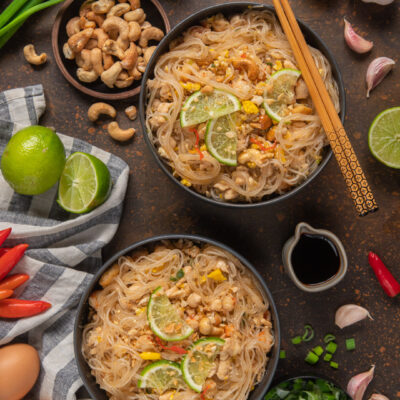 Pad thai con noodles di riso, anacardi, peperoncino e fette di lime