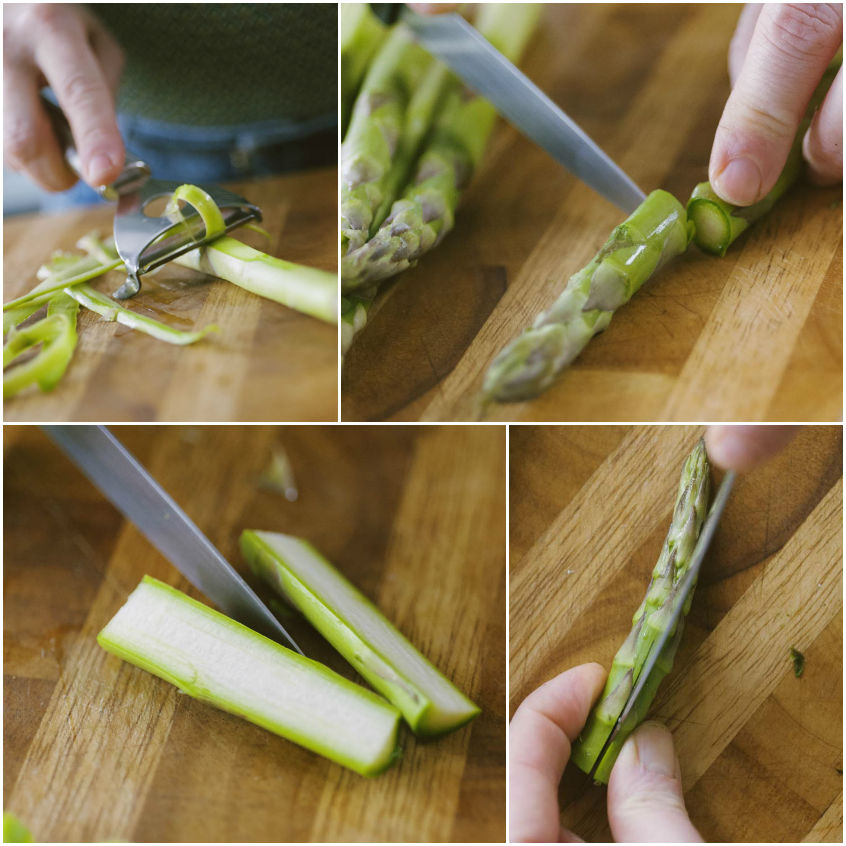 Asparagi puliti, pelati e tagliati a metà sul tagliere con coltello e pelapatate