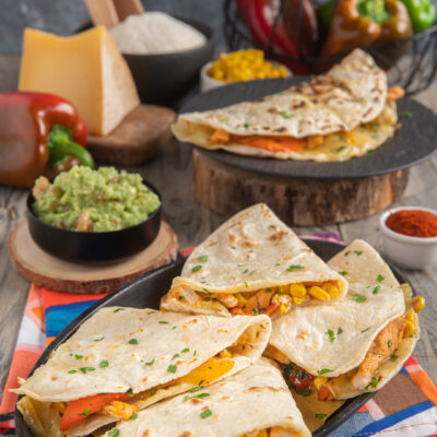 Quesadillas ripiene di pollo, peperoni e mais con guacamole e prezzemolo fresco