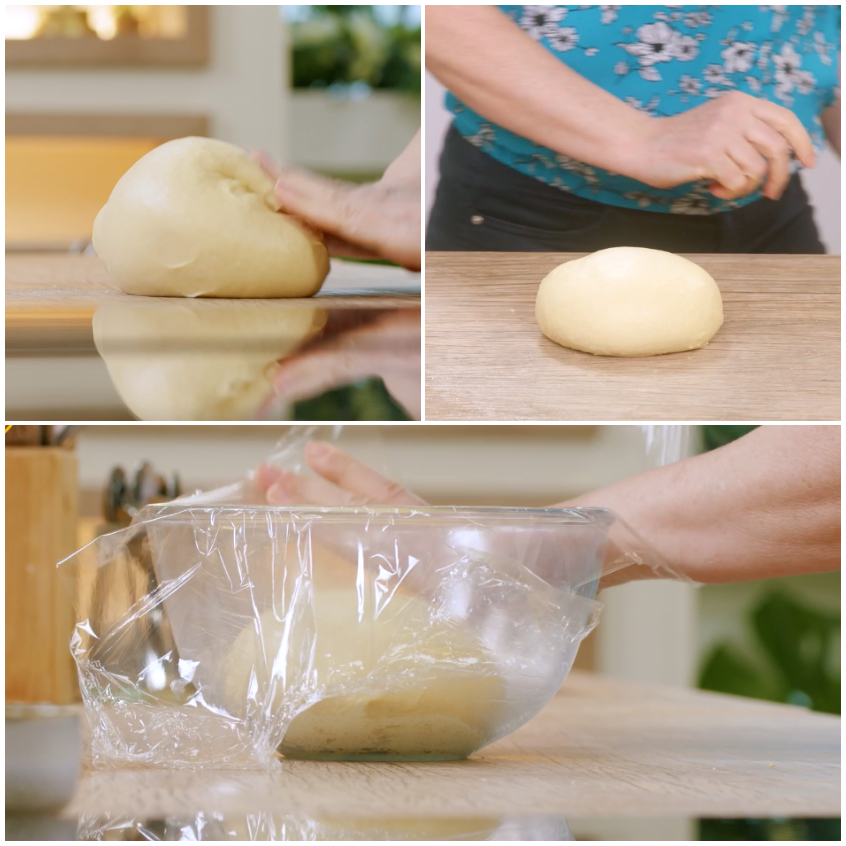 Impasto del pane al latte lavorato a mano, formato a palla e coperto con pellicola per lievitare