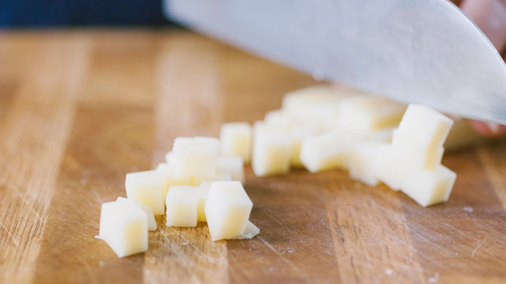 Dadolata di fontina e caciocavallo tagliati a cubetti regolari per l'insalata di riso
