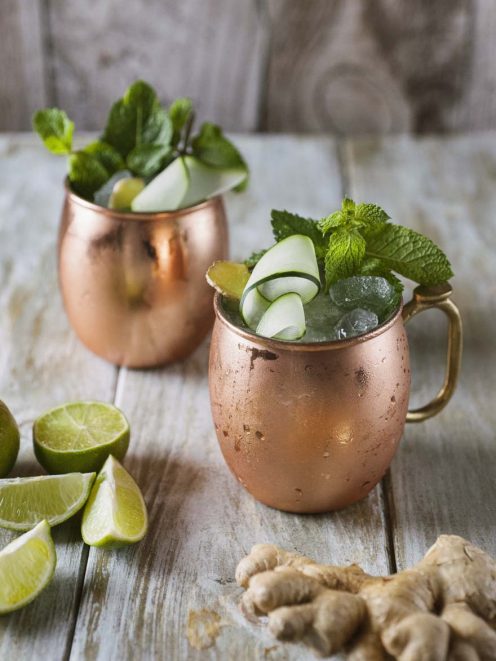 Moscow Mule in tazze di rame con ghiaccio, menta fresca, cetriolo arrotolato e zenzero