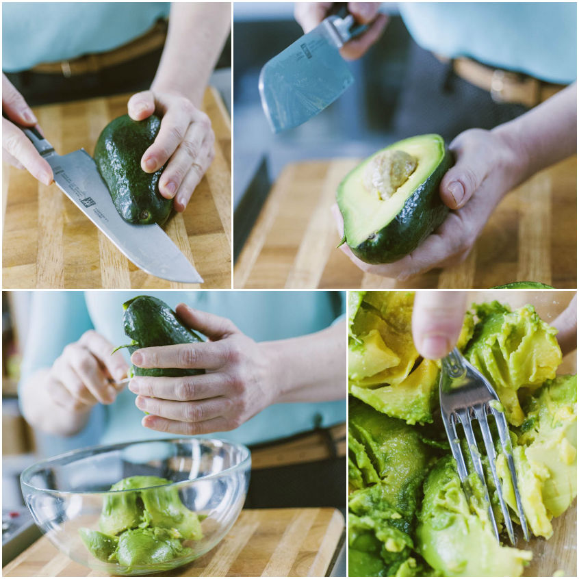 Avocado tagliato a metà, svuotato e schiacciato con una forchetta per il guacamole