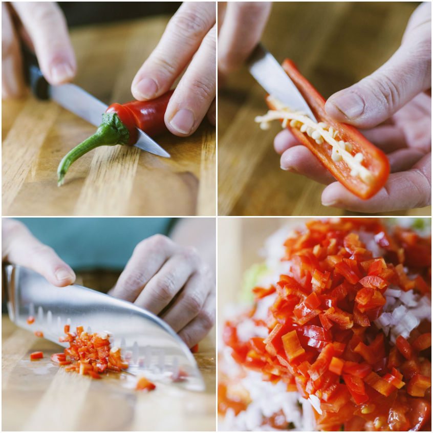 Peperoncino rosso tagliato a metà, privato dei semi e tritato finemente sul tagliere