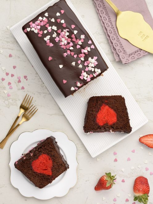 Surprise cake al cioccolato con cuore rosso nascosto e glassa decorata da codette a forma di cuoricino