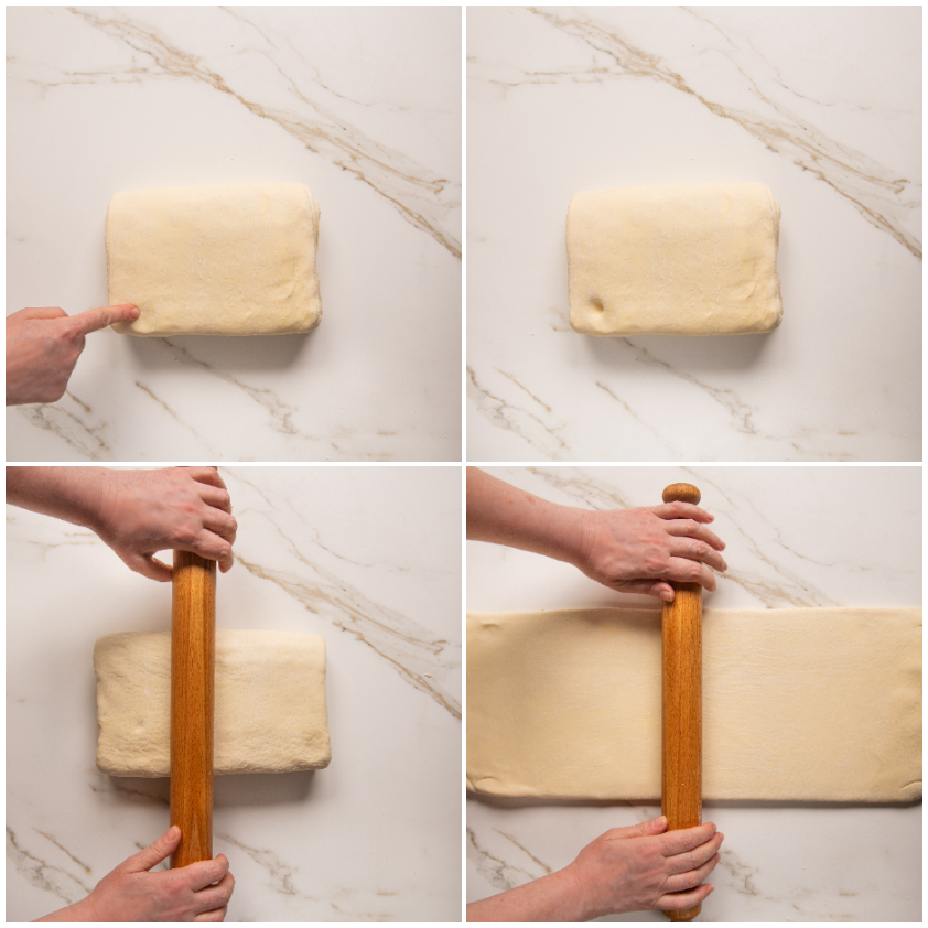 Panetto di pasta sfoglia steso con il mattarello in senso verticale sul piano di lavoro