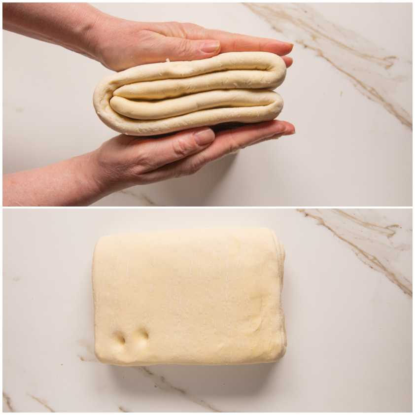 Impasto della pasta sfoglia piegato a strati tenuto tra le mani, poi adagiato sul piano di lavoro