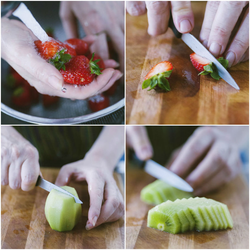 Fragole lavate e tagliate a spicchi, kiwi sbucciato e affettato sul tagliere