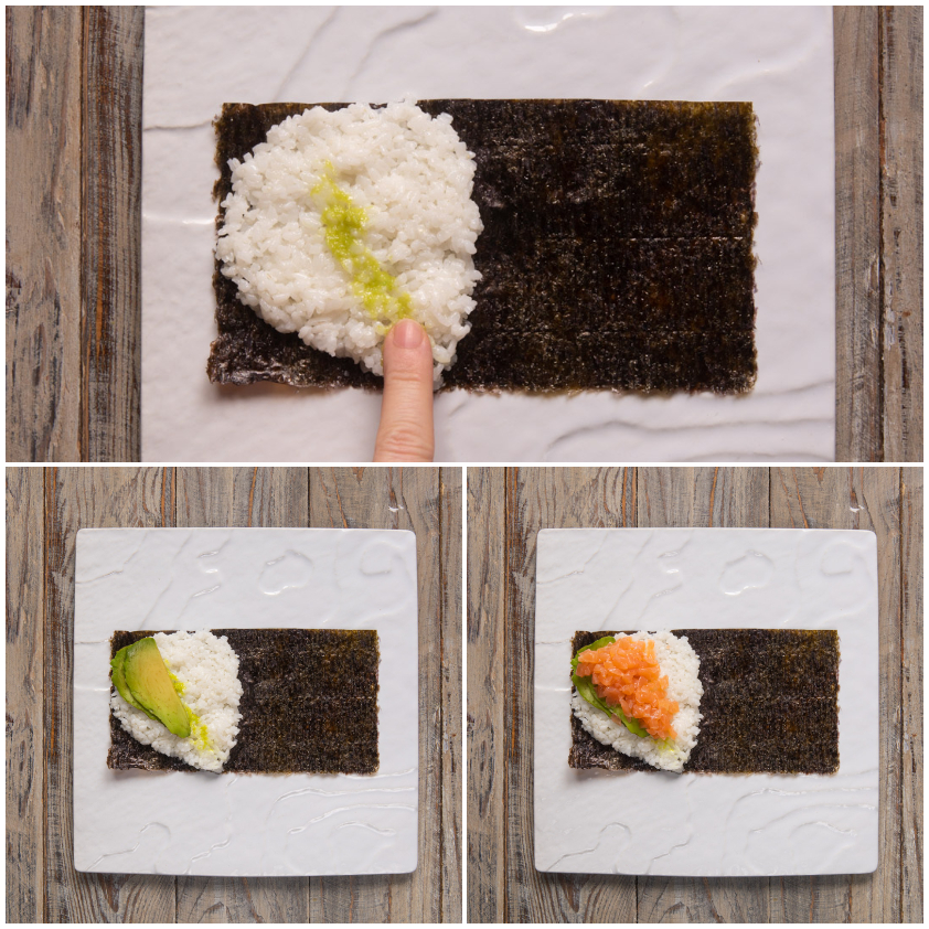 Striscia di wasabi sul riso, poi avocado e salmone disposti sul foglio di nori