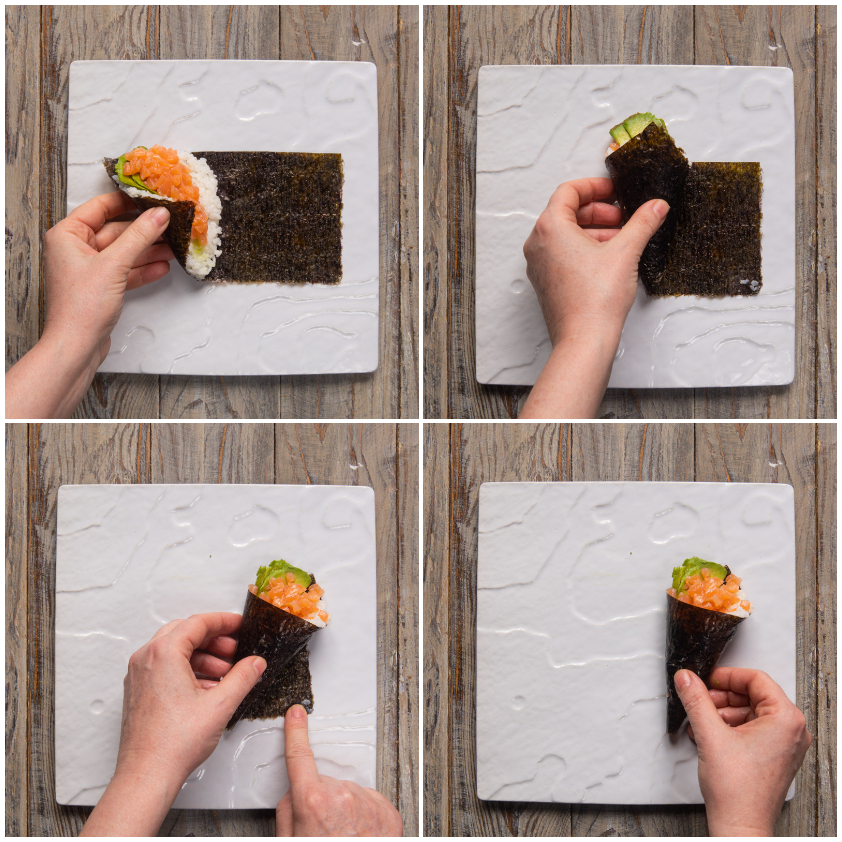 Mani che arrotolano l'alga nori con salmone e avocado formando un cono di temaki