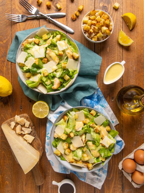 Caesar salad con lattuga romana, pollo grigliato, crostini dorati, scaglie di parmigiano e dressing cremoso