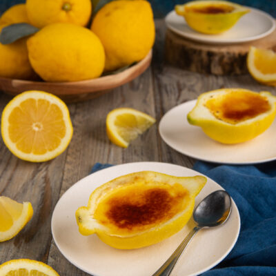 Crème brûlée nel limone con superficie caramellata servita in mezzi limoni svuotati