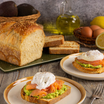 Avocado toast con pane in cassetta all'avena, salmone affumicato e uovo in camicia