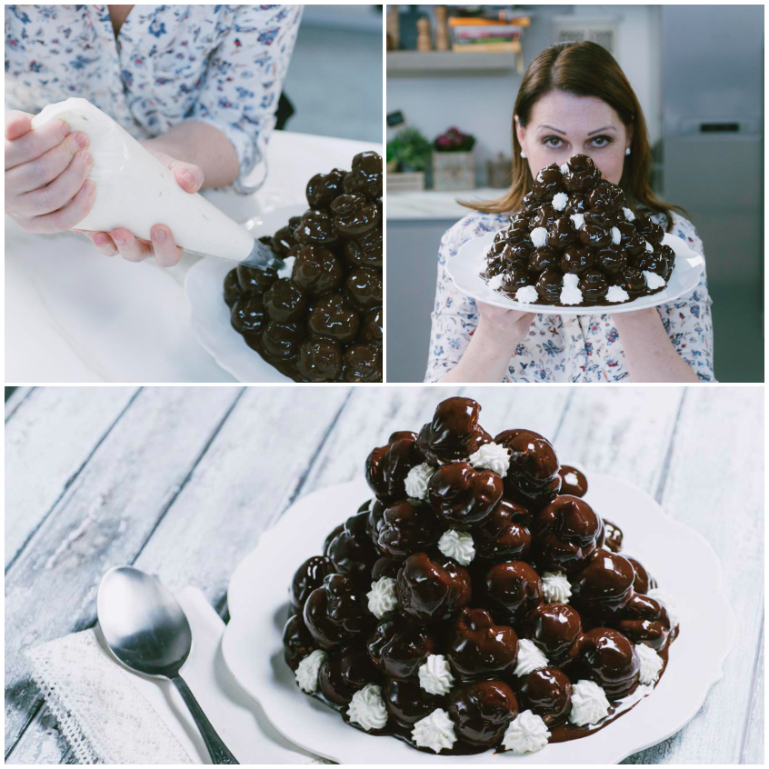 Profiteroles glassati al cioccolato composti a piramide con ciuffetti di panna tra gli strati