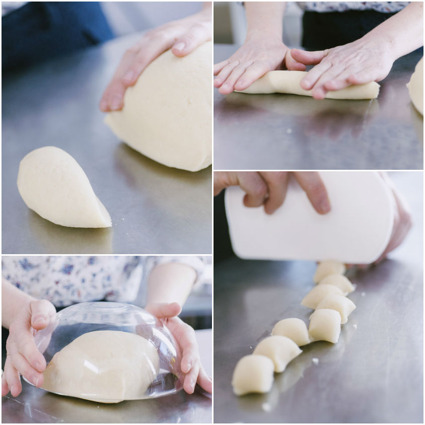 Impasto per gnocchi diviso in porzioni: un filoncino viene tagliato a tocchetti sul piano di lavoro