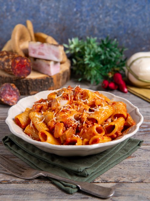 Rigatoni alla silana conditi con sugo di pomodoro e salsiccia, spolverati di formaggio grattugiato
