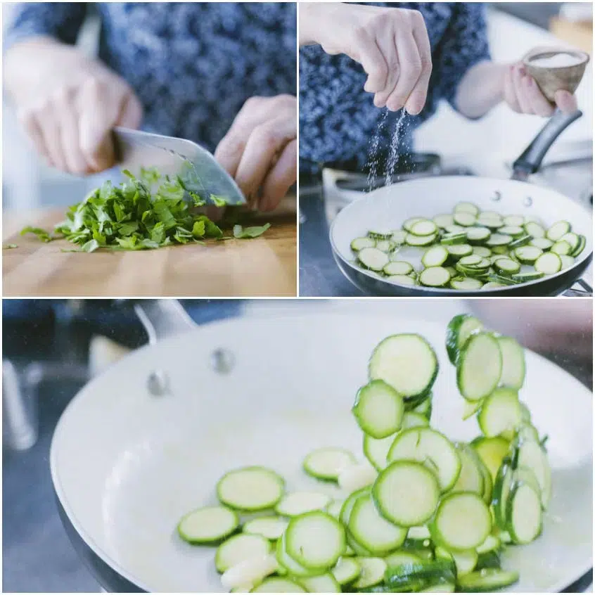Zucchine a rondelle saltate in padella con aglio, mentre si trita del prezzemolo sul tagliere