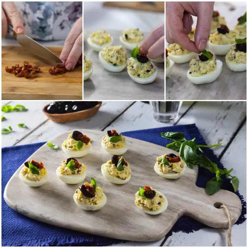 Uova sode farcite decorate con pomodori secchi, olive nere e foglioline di basilico fresco