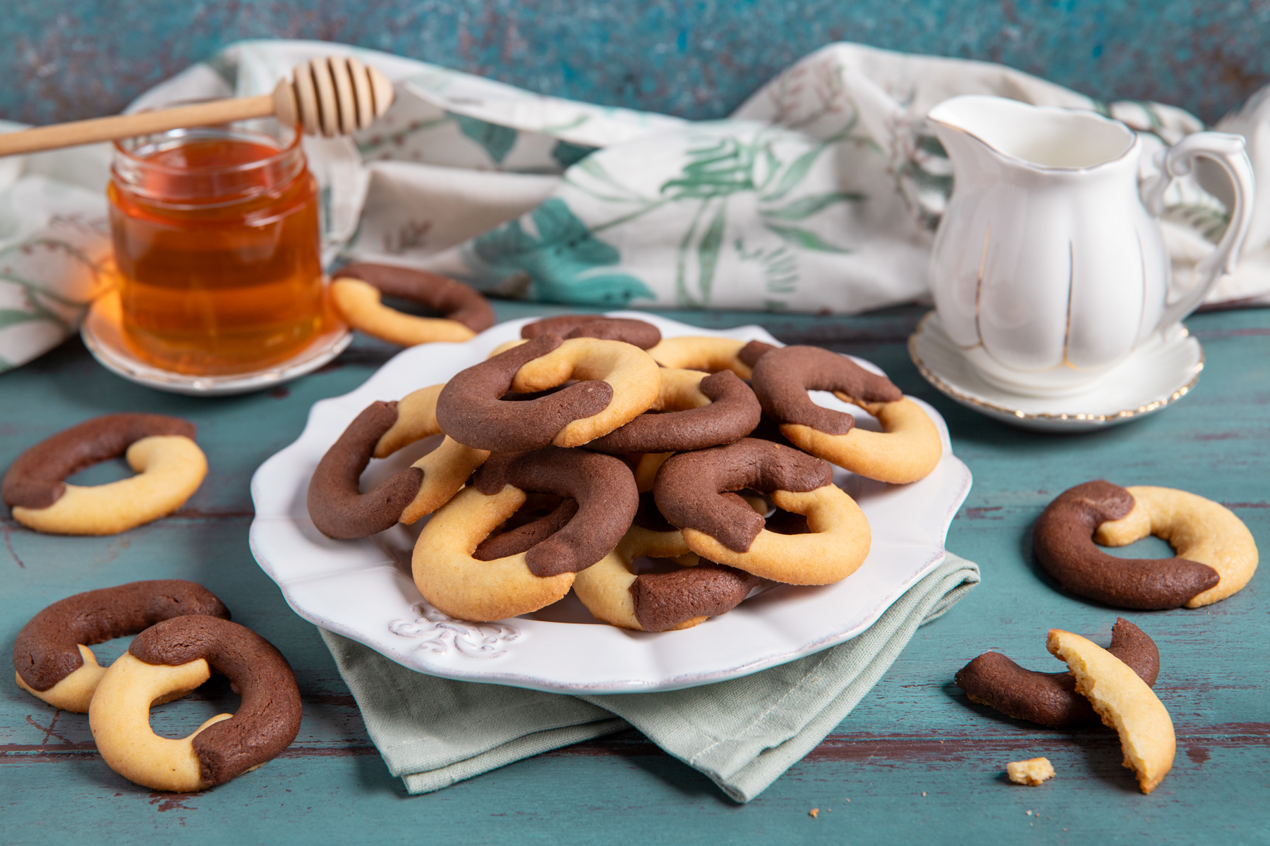Biscotti abbracci al cacao e vaniglia a forma di mezzaluna, impilati e pronti da servire